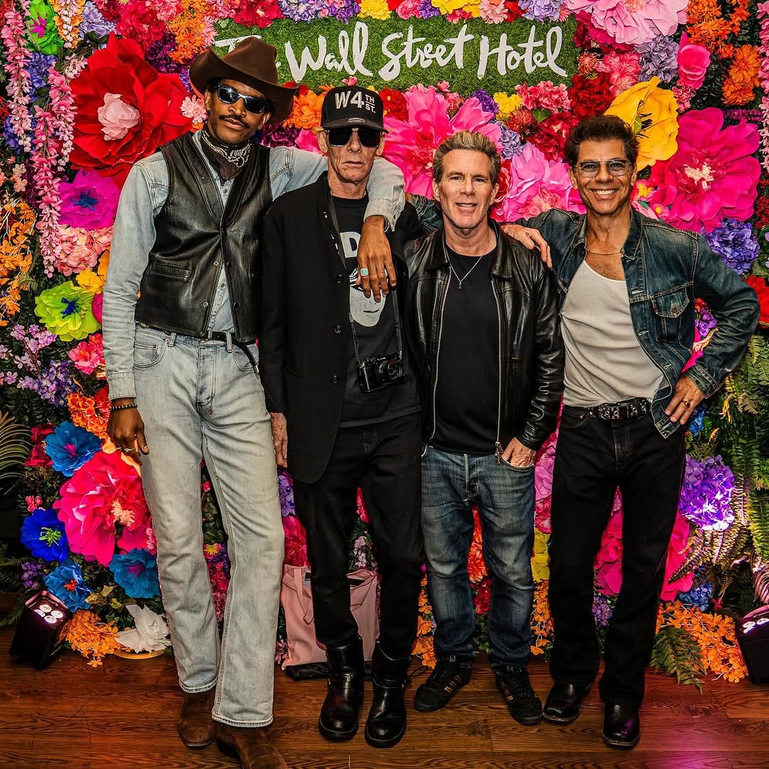 A guest photographed at the Wall Street Hotel flower wall