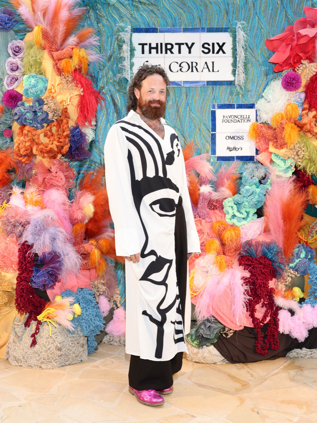 Shelton Lindsay standing before one of his crocheted coral installations, Thirty Six for Coral